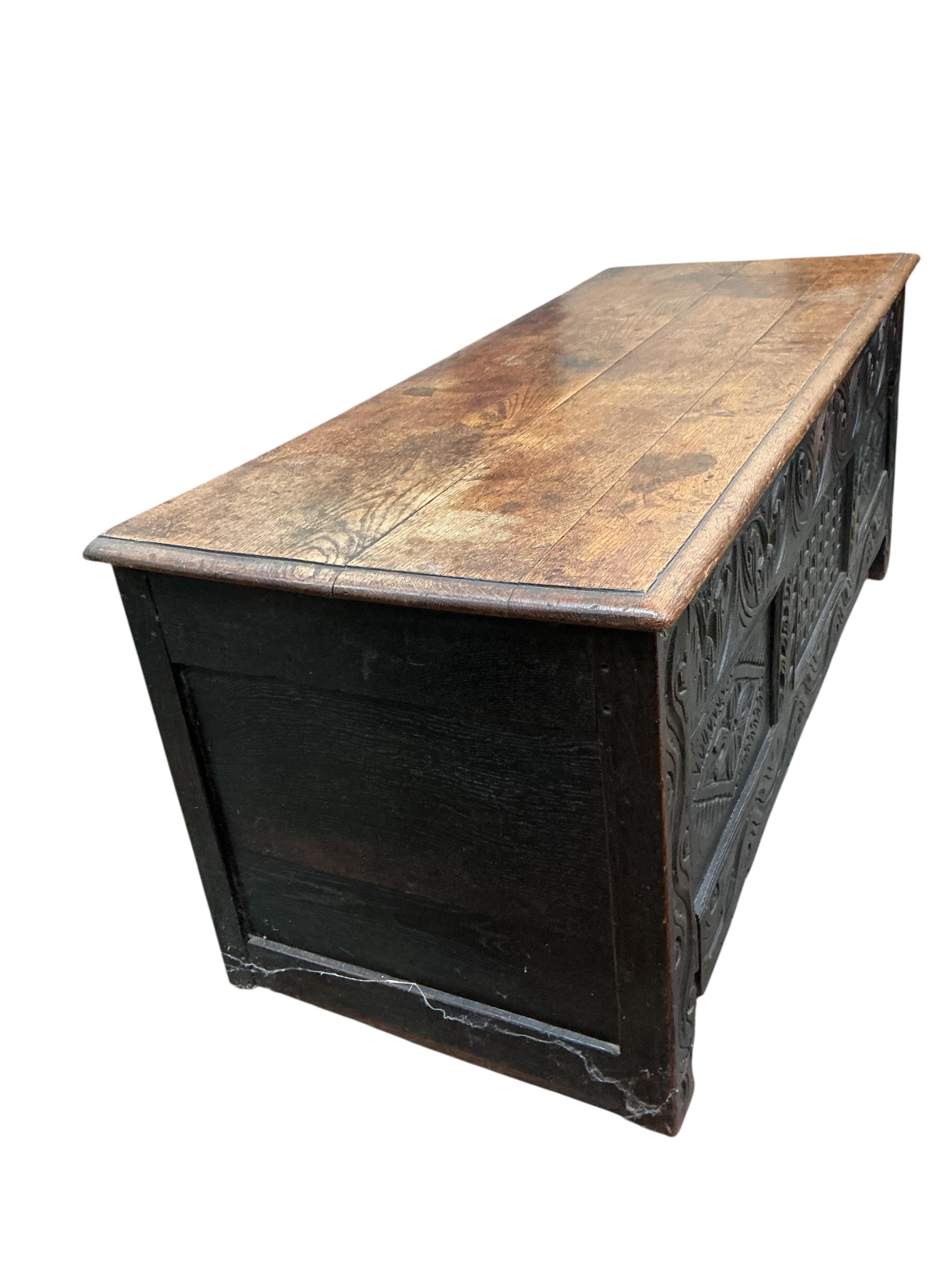 An 18th century panelled oak coffer, width 136cm, depth 54cm, height 56cm